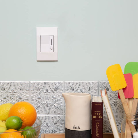 Deako Simple Dimmer switch on a light colored kitchen wall